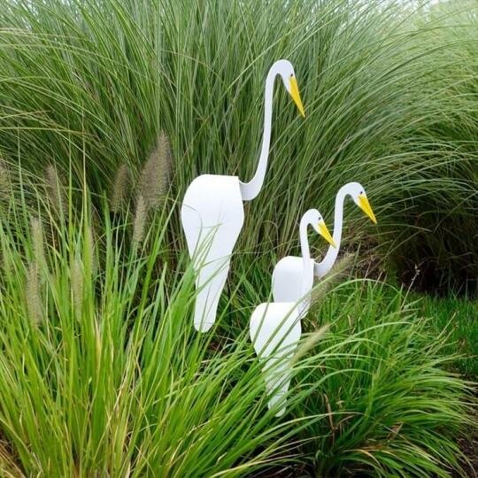 A whimsical and dynamic bird that spins with the slight garden breeze